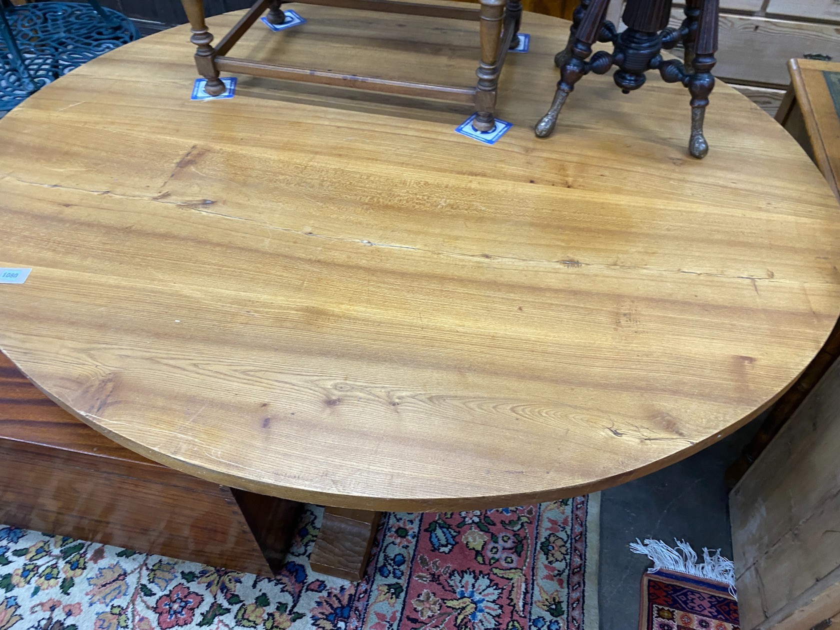 A 'Woodpecker Man' adzed oak dining table, with oval top and chip carved underframe, 170cm x 146cm